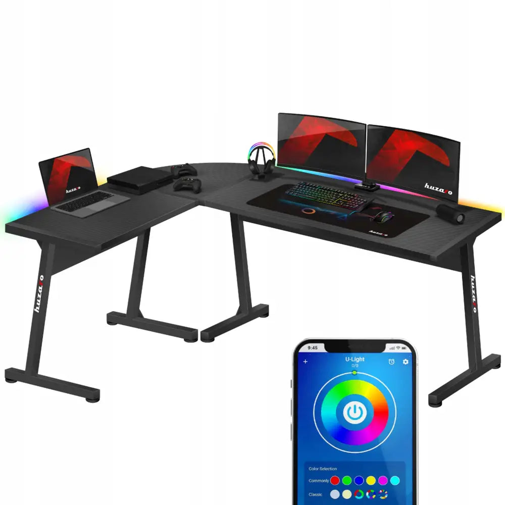 Tenåringsrom, moderne hjørneskrivebord med sort overflate, to skjermer, bærbar PC og LED-lys i ulike farger.