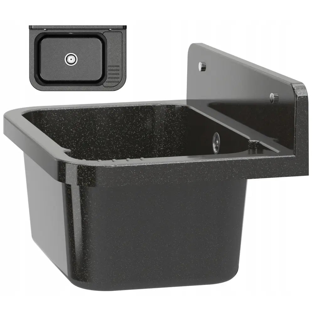 Utslagsvask, mørk rektangulær servant med avrundede hjørner og prikket overflate montert på vegg.