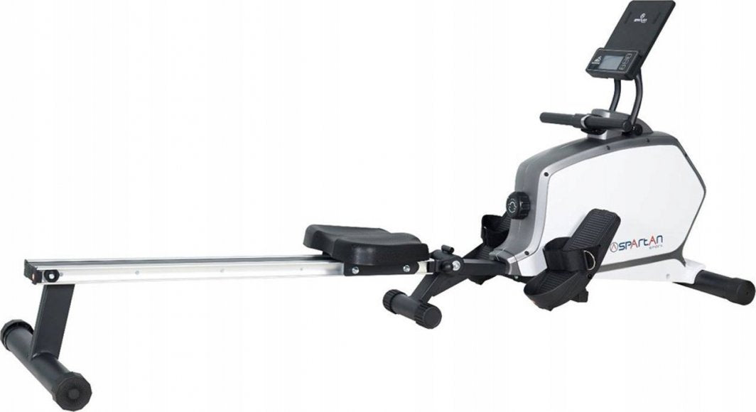 Romaskin i sort, hvitt og grått med polstret sete, fotstøtter og digital skjerm, sett fra siden.