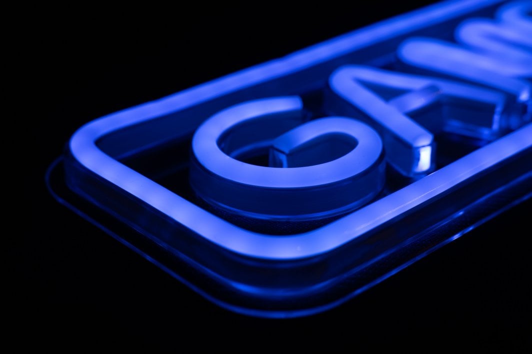 Sammenleggbar tredemølle Neonskilt Game On blå LED sett fra siden med akrylramme og lysende hjørne.