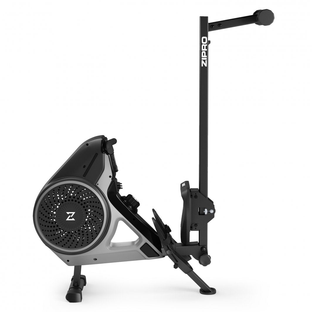 Romaskin Sammenleggbar i svart og grått, sett fra siden, oppreist for oppbevaring med pedal og håndtak synlig.