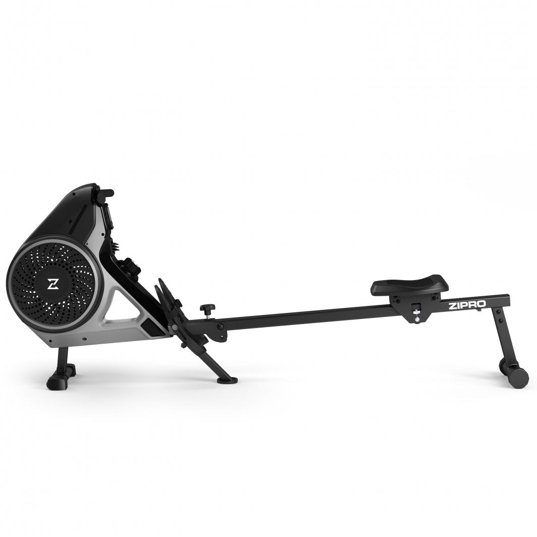 Sammenleggbar Romaskin i sort og sølv, sett fra siden med sete, fotstøtter og hovedmekanisme med ventilasjonshull.