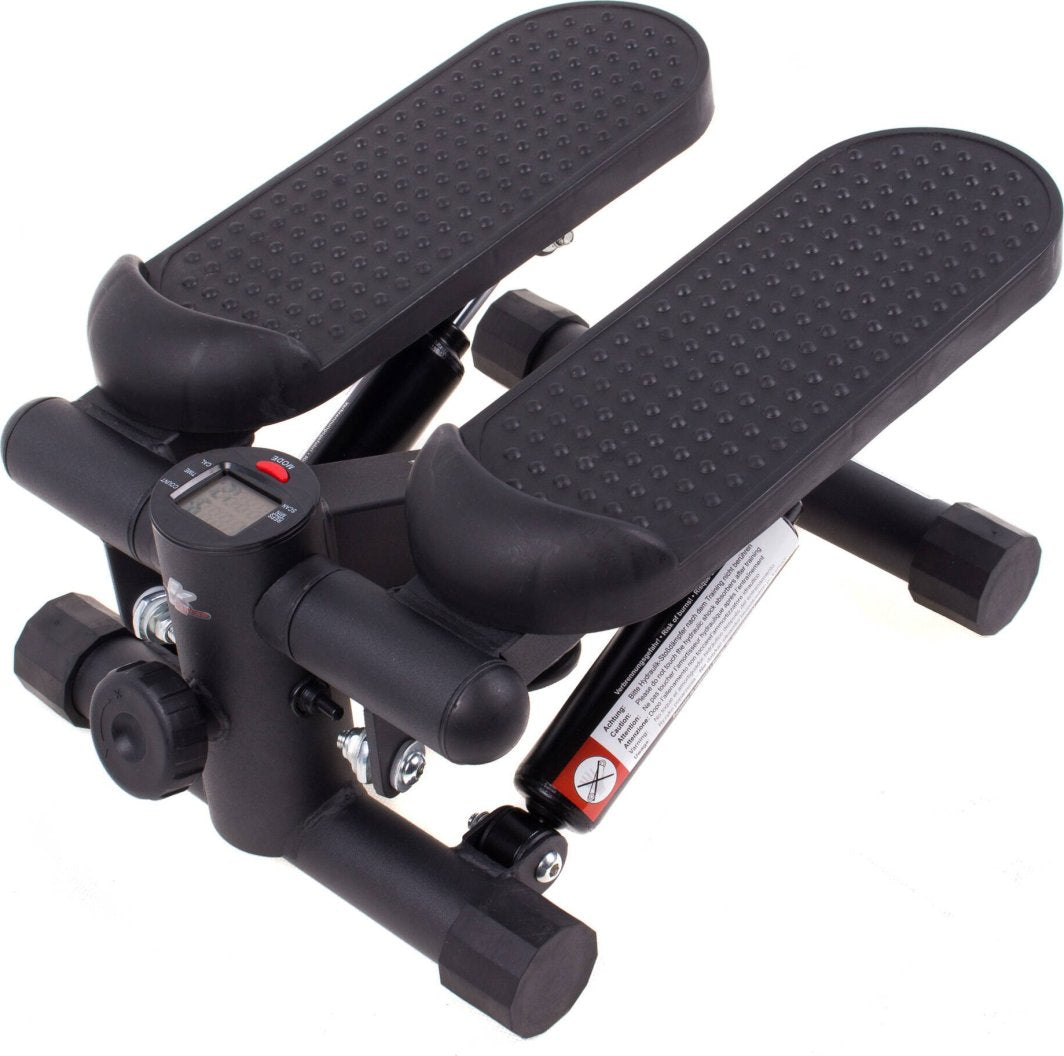 Stepmaskin i sort plast og metall med to brede antiskli-fotplater og digital skjerm, sett fra skrå vinkel.