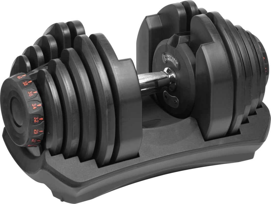 Hantel i sort plast og metall med røde tall for vektvalg, sett forfra i stativ med strukturert håndtak.