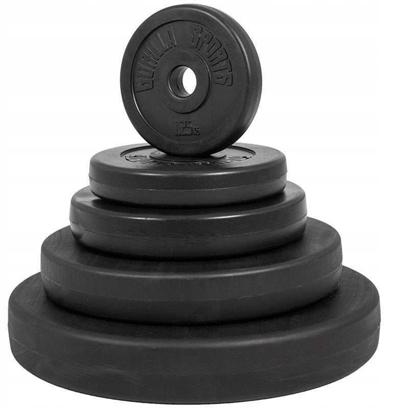 Vektplate i sort vinyl, stablet med flere vektplater i ulike størrelser, rund form og 30 mm hull, sett skrått.