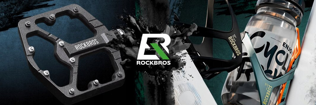 Sykkelbriller Klart Glass foran sort metallpedal til venstre og flaskebøyle med drikkeflaske på sykkelramme til høyre.