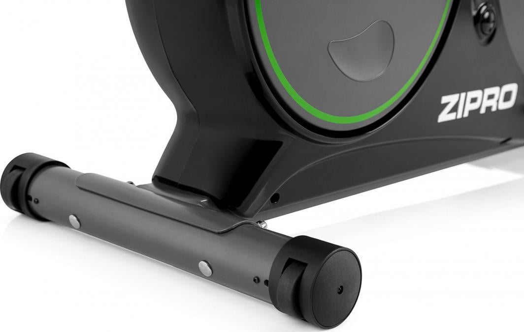 Treningssykkel detaljbilde av nedre del med stabilisatorhjul, sort og grå ramme med grønn stripe fra siden.