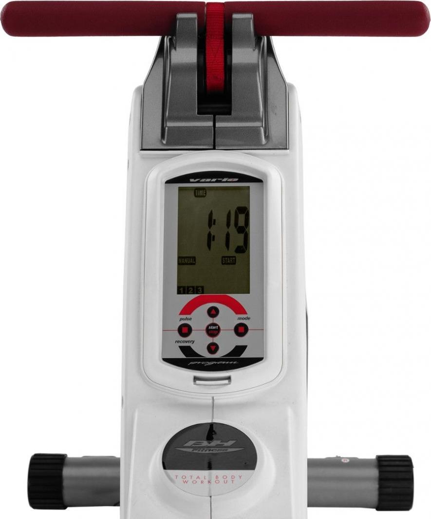 Romaskin i hvit og grå plast med rødt håndtak, sett ovenfra, viser display, knapper og justeringshjul på sidene.