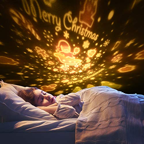 Stjernehimmel Projektor projiserer varme gule julemotiver og teksten "Merry Christmas" over et sovende barn.