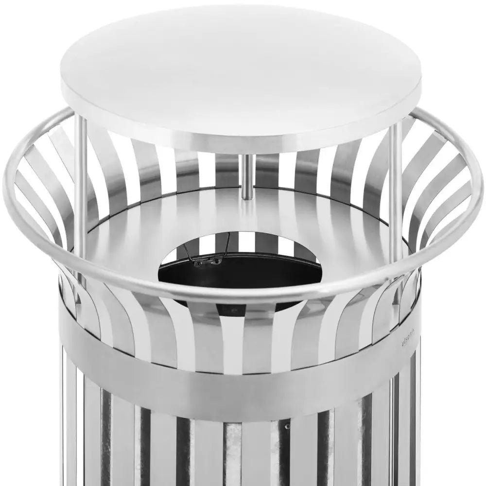Avfallsbøtte i rustfritt stål, nærbilde ovenfra som fremhever rund åpning og beskyttende lokk.