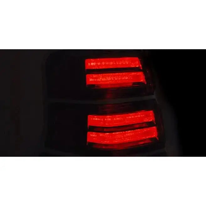 Baklys Black Toyota Land Cruiser 150 med røde LED-striper, vist skrått mot mørk bakgrunn.