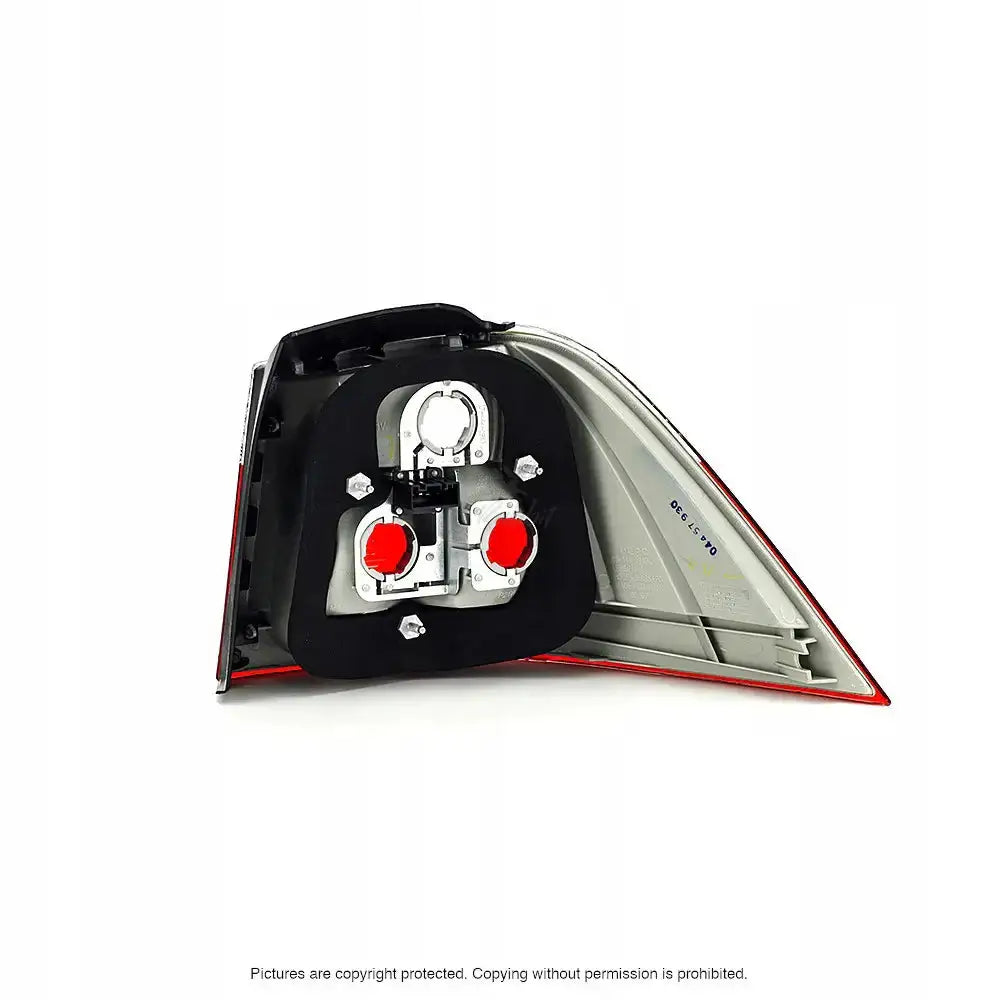 Baklykter Bmw 5 Serie E61 bakside med synlig pæreholder og to røde deksler mot lys bakgrunn.