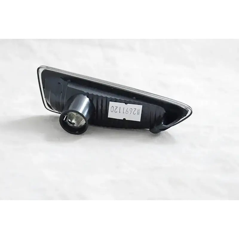 Baklykt Opel Astra J 10 smoke sett bakfra med synlig lyspære og hvit etikett på lyst underlag.