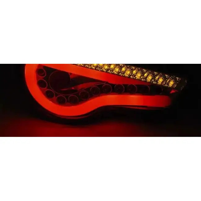 Baklykter Toyota GT86 12- Led Bar Black med S-formet rødt og gult lysmønster i mørket.