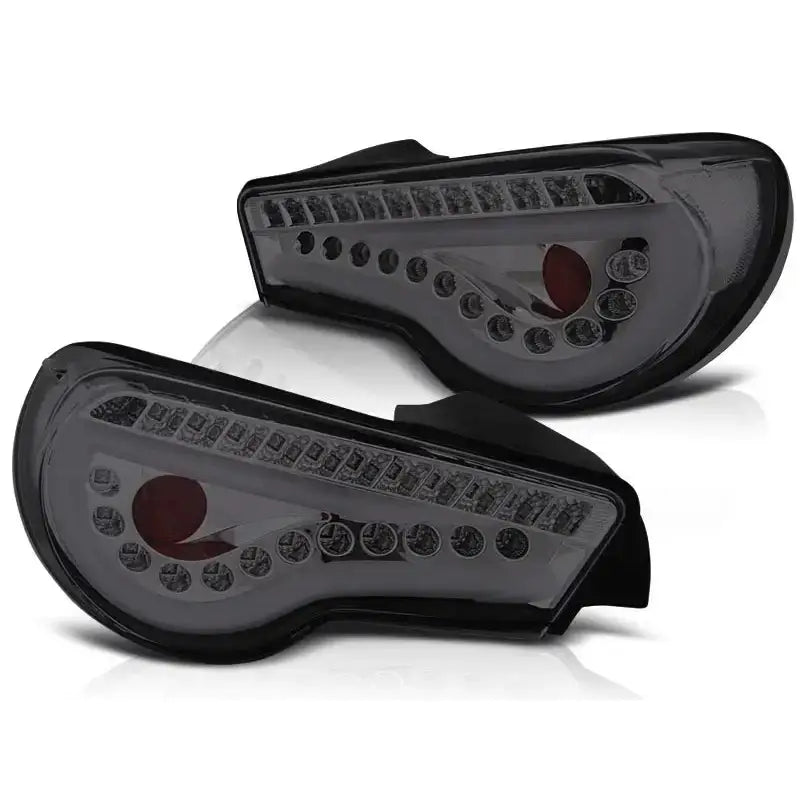 Baklykt Toyota GT86 12- Led Bar Smoke, svart med klart glass og LED, vises fra for- og bakside.