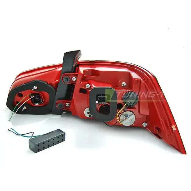 Baklamper VW Passat B7 baklykt med røde og hvite felt, synlige ledninger og kontaktadapter.