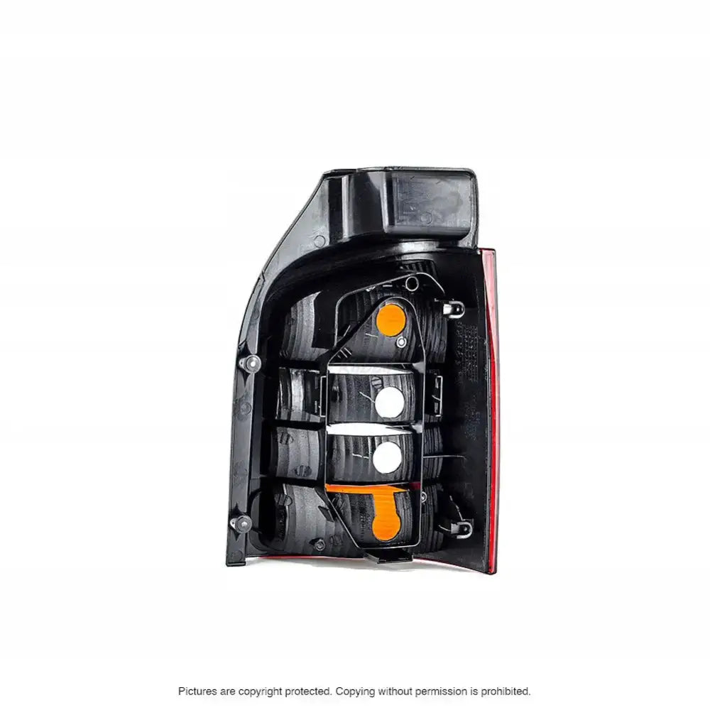 Baklykt Vw T5 Transporter 03-09 sett fra innsiden med oransje og hvite detaljer samt monteringspunkter.
