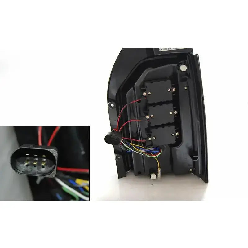 Baklykter Vw T6 2015 bakside med synlige ledninger og firkantet kontakt med fire metallpinner.