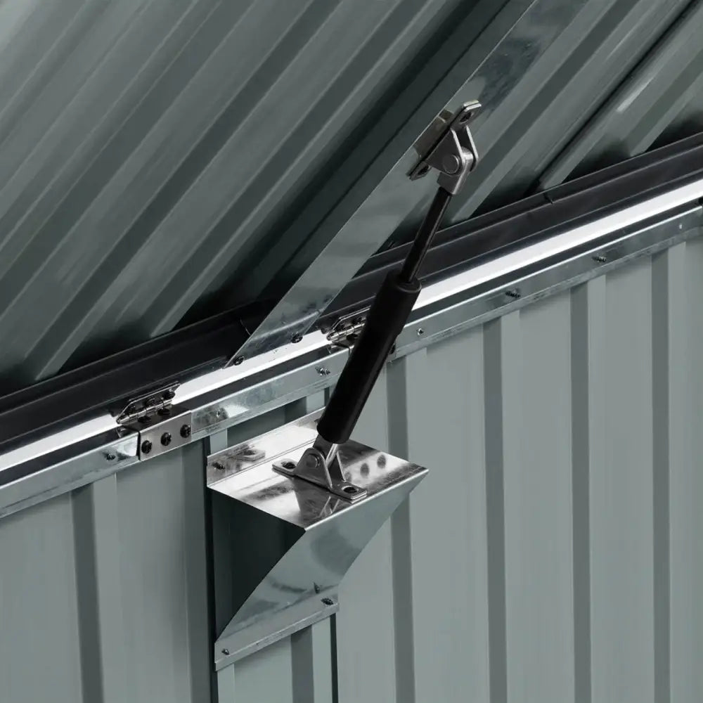 Beskyttelsesdeksel for metallavfallsbeholdere, nærbilde av gassdemper og hengslet feste på innsiden av lokket.