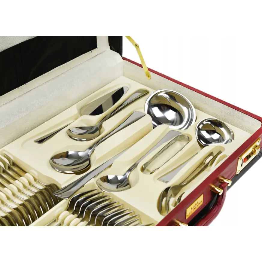 Bestikksett med 72 deler i polert stål, elegant arrangert i kremfarget form i rød koffert med gullfargede detaljer.