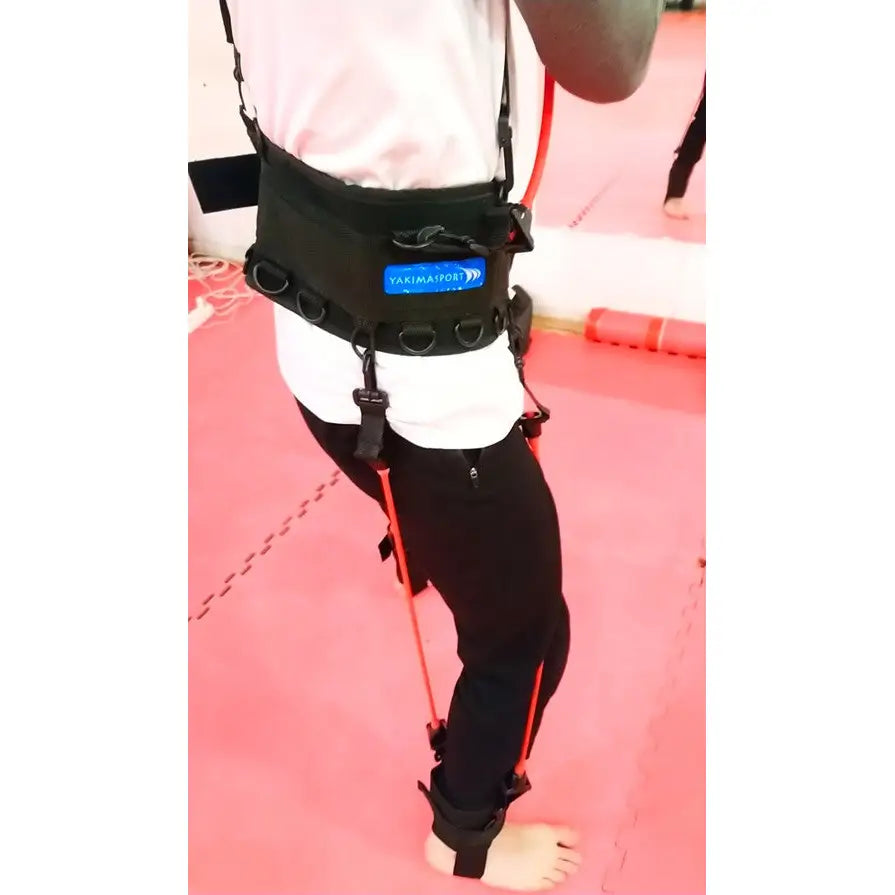 Boksetrening Kaugummi, svart treningsvest med røde strikker i bruk fra siden på person med hvit t-skjorte.