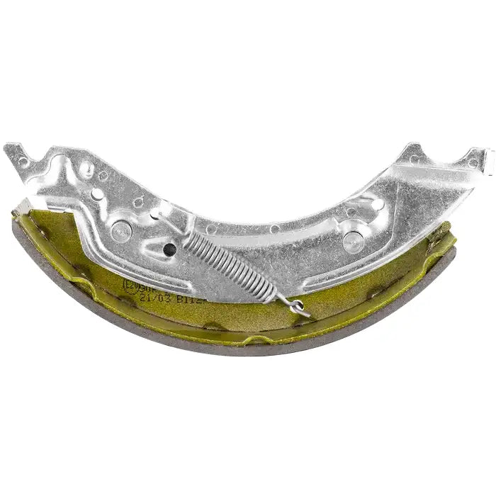 Bremsesko med gulgrønn bakside og sølvfarget fjær, sett fra siden med synlig friksjonsbelegg.