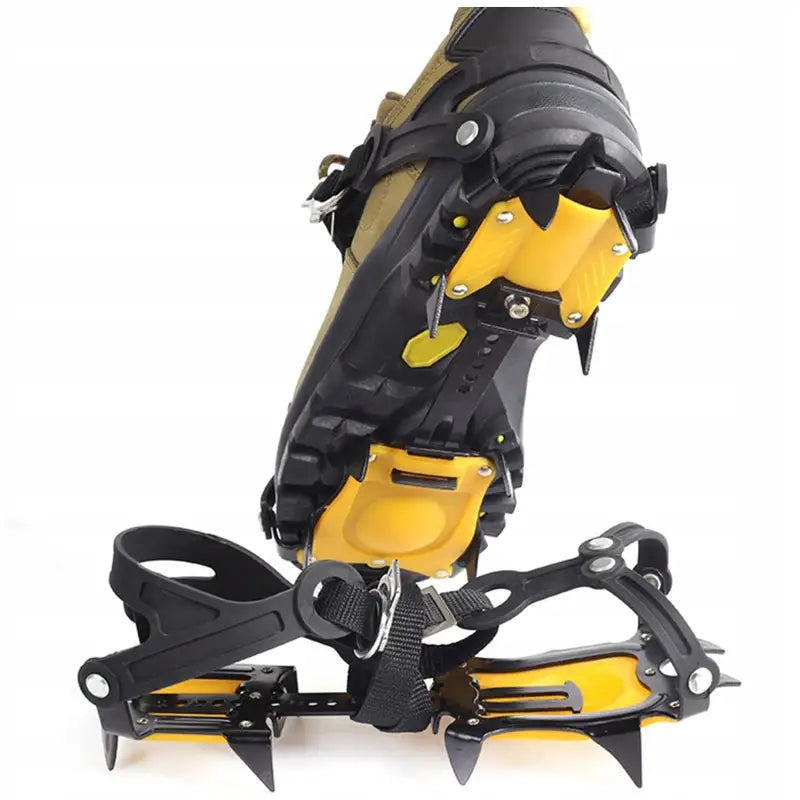 Brodder for basketballsko, gule og svarte stegjern med metallpigger og festebånd montert på fjellstøvel.