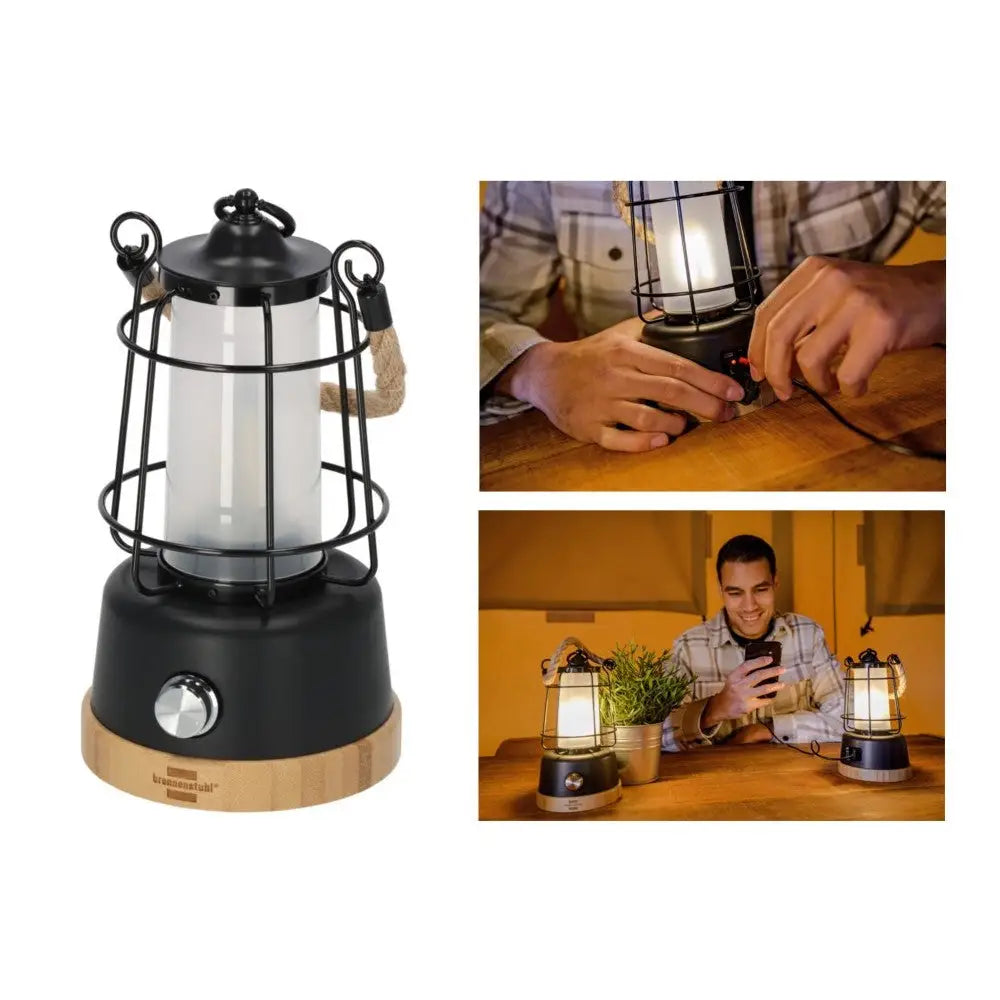 Campinglampe i retrostil med svart og trehvit finish, tauhåndtak og synlig varm belysning på bord.