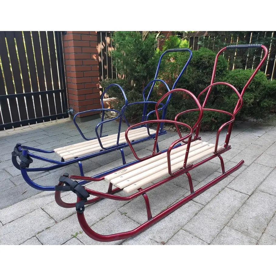 Dobbel tandem akebrett med rød og blå metallramme, lyse trestaver og høye håndtak, utendørs på stein.