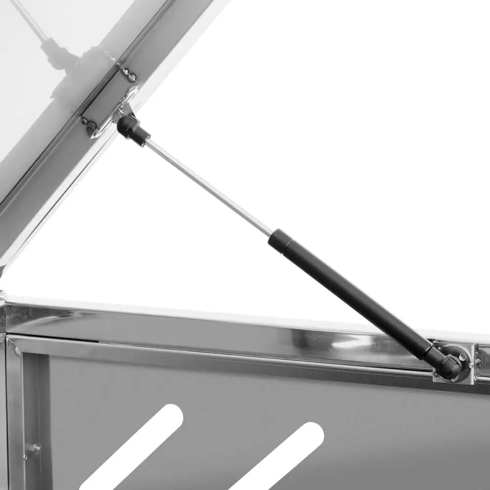 Dobbelt avfallskurv deksel, detaljert visning av sort og sølv gassfjær-mekanisme og feste til metallokk.