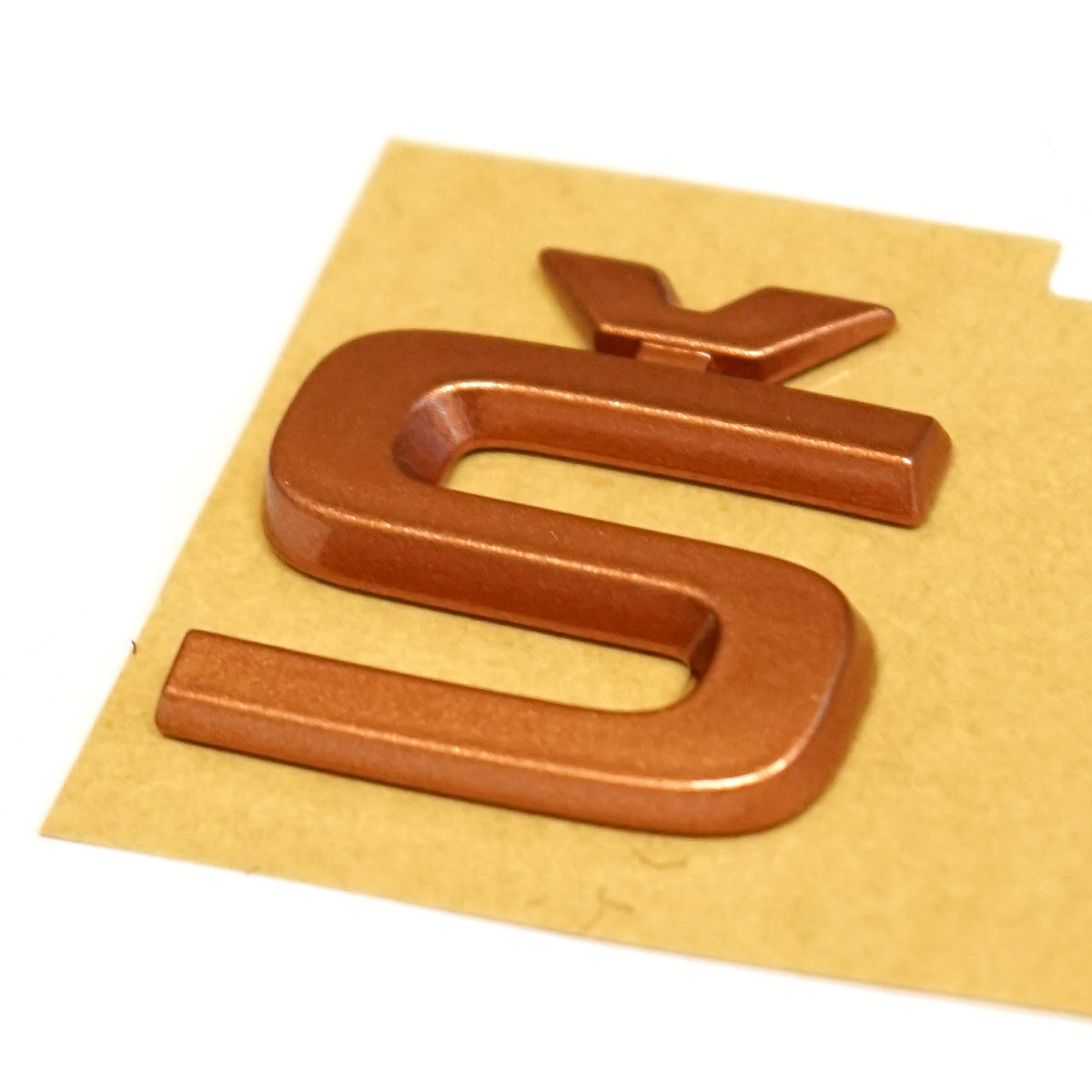 Emblem Skoda Enyaq > Penny Copper metallic - sett forfra