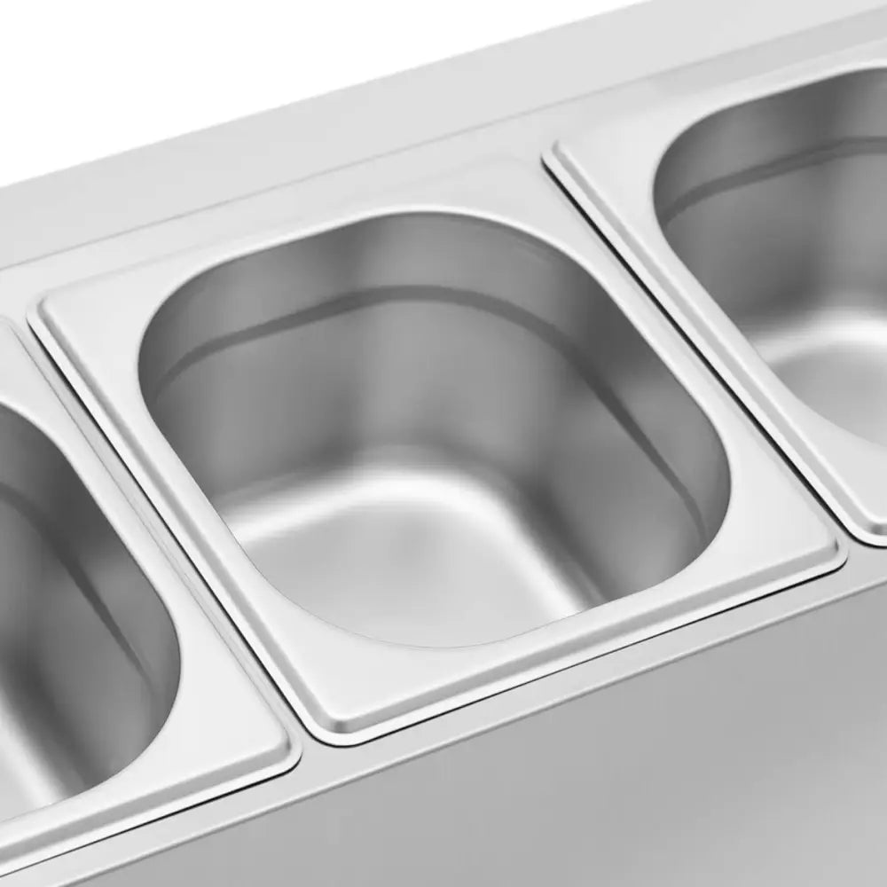 Ekspansjonsstativ med tre GN 1/6 beholdere og lokk, sett ovenfra i blankt rustfritt stål.