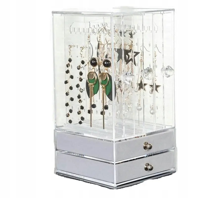 Elegant smykkeskap øredobberstativ, skrå front med grønne og sorte øreringer og to skuffer nederst.