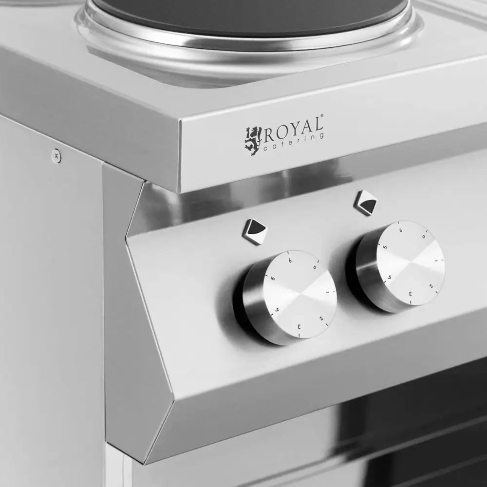 Elektrisk 6-brenners kjøkken, nærbilde av sølvfargede dreieknapper med tall og synlig logo på stålfront.