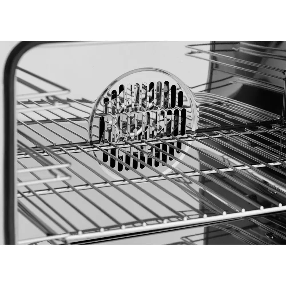 Ovnsrom i rustfritt stål med flere rister og sentralt ventilasjonsdeksel, detaljvisning av interiøret.