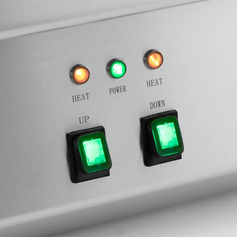 Elektrisk deep fryer betjeningspanel, viser tre varsellamper og to grønne brytere merket med temperaturkontroll.