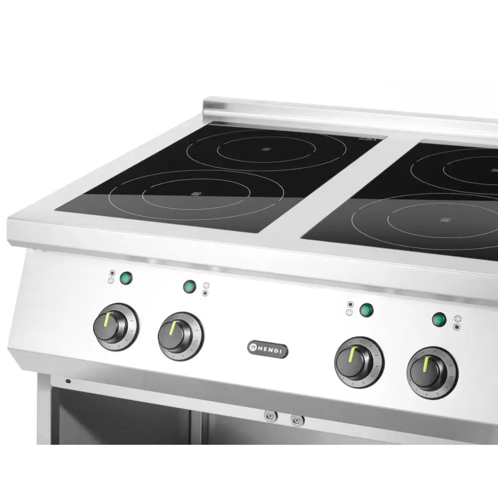 Elektrisk induksjonstopp med fire sirkulære kokeplater, kontrollknotter og grønne indikatorlys, skrå vinkel.