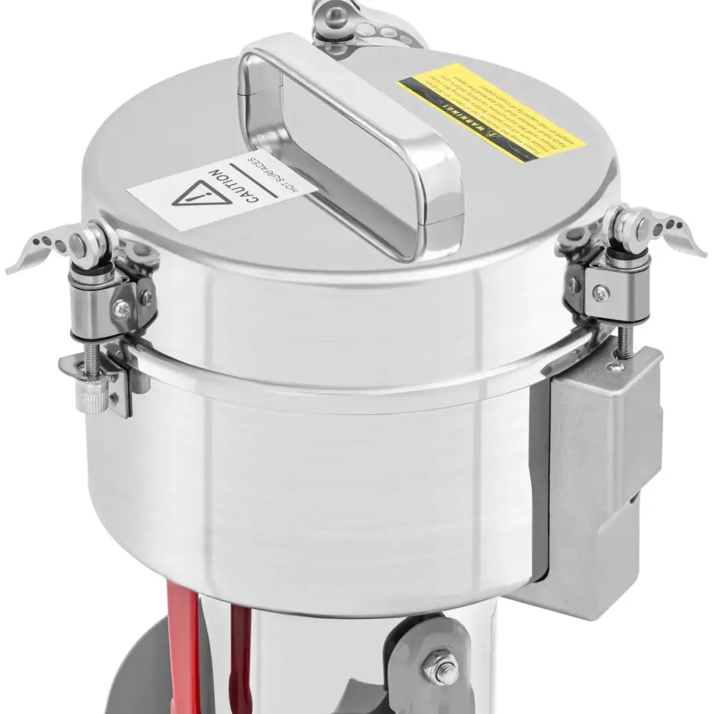 Elektrisk krydderurter og nøtter kvern, sidevisning av rustfri beholder med låsemekanismer og advarselsmerker.