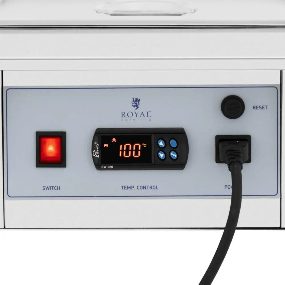 Elektrisk sjokoladesaus varmere, nærbilde av kontrollpanel med digital temperaturvisning og røde brytere.