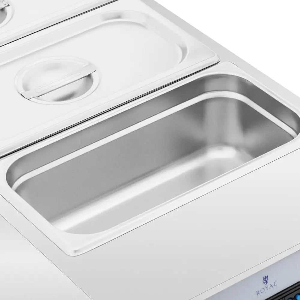 Elektrisk sjokoladesmelter med tre åpne stålinnsatser, sett ovenfra, viser glatte kanter og blank overflate.