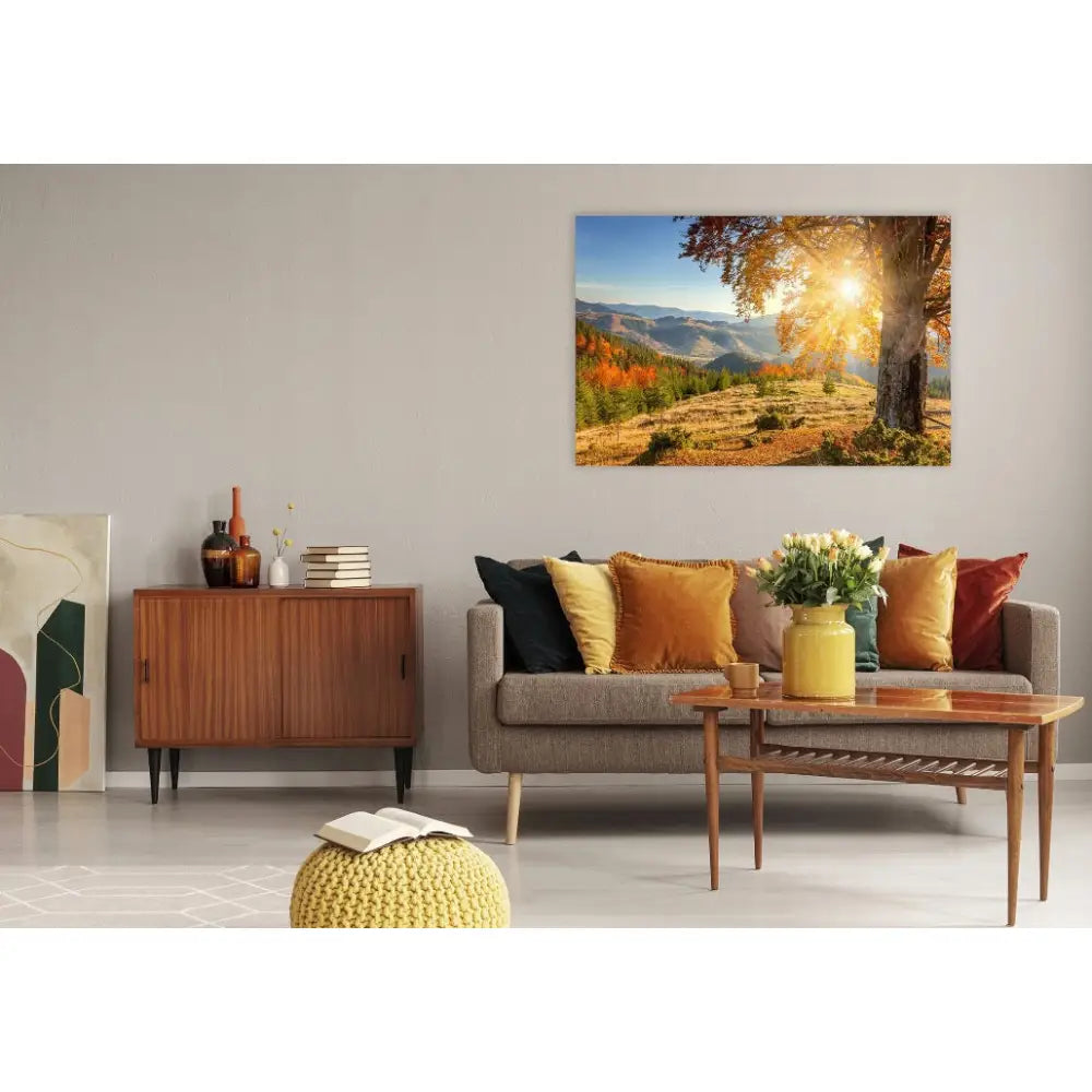 Fjell og tre lerretsbilde, høstlandskap med sollys over grå sofa og fargerike puter i moderne stue.