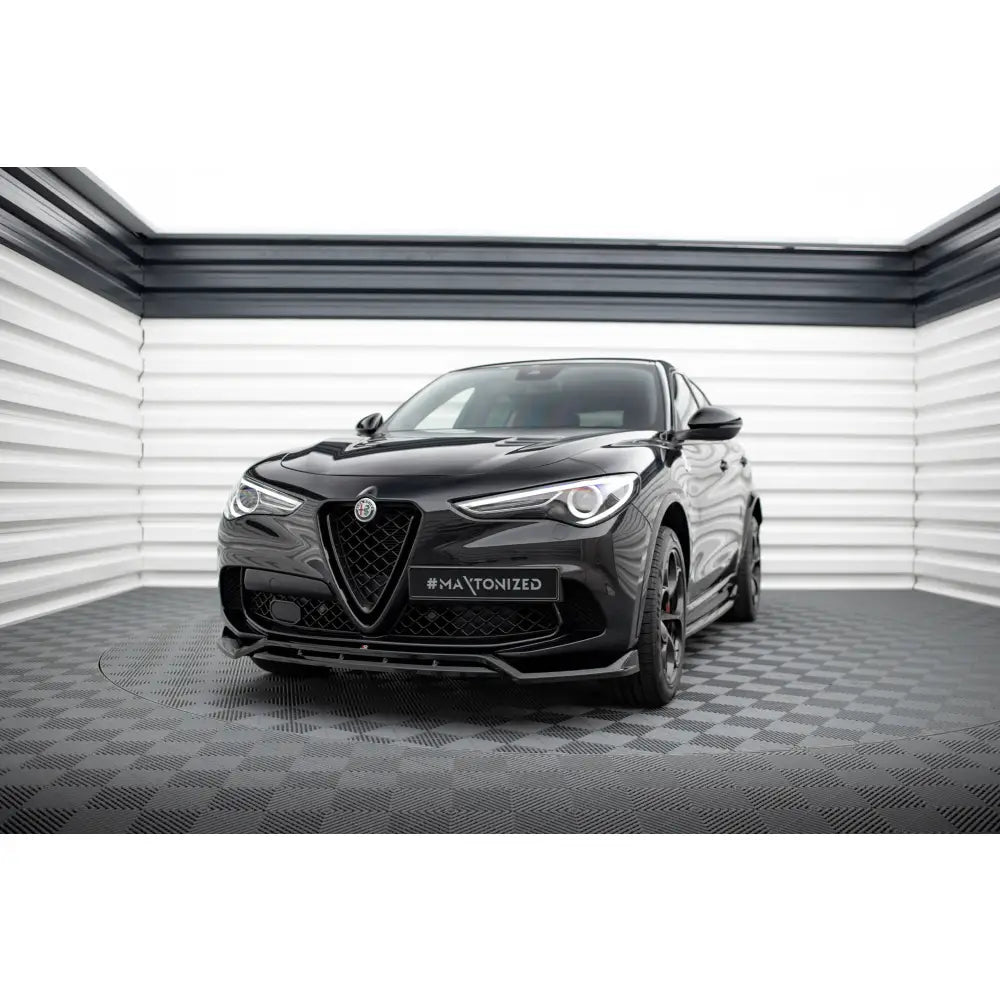 Frontleppe på Alfa Romeo Stelvio Quadrifoglio Mk1 sett forfra i lyst rom med rutete gulv.