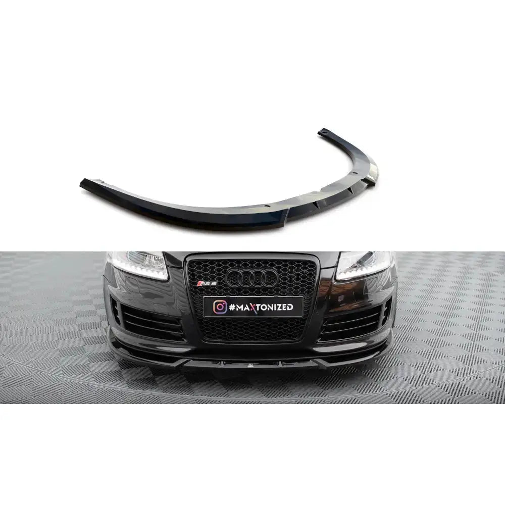 Frontspoiler Audi RS6 C6 V2 i sort blank plast med aerodynamiske detaljer, vist mot hvit bakgrunn.
