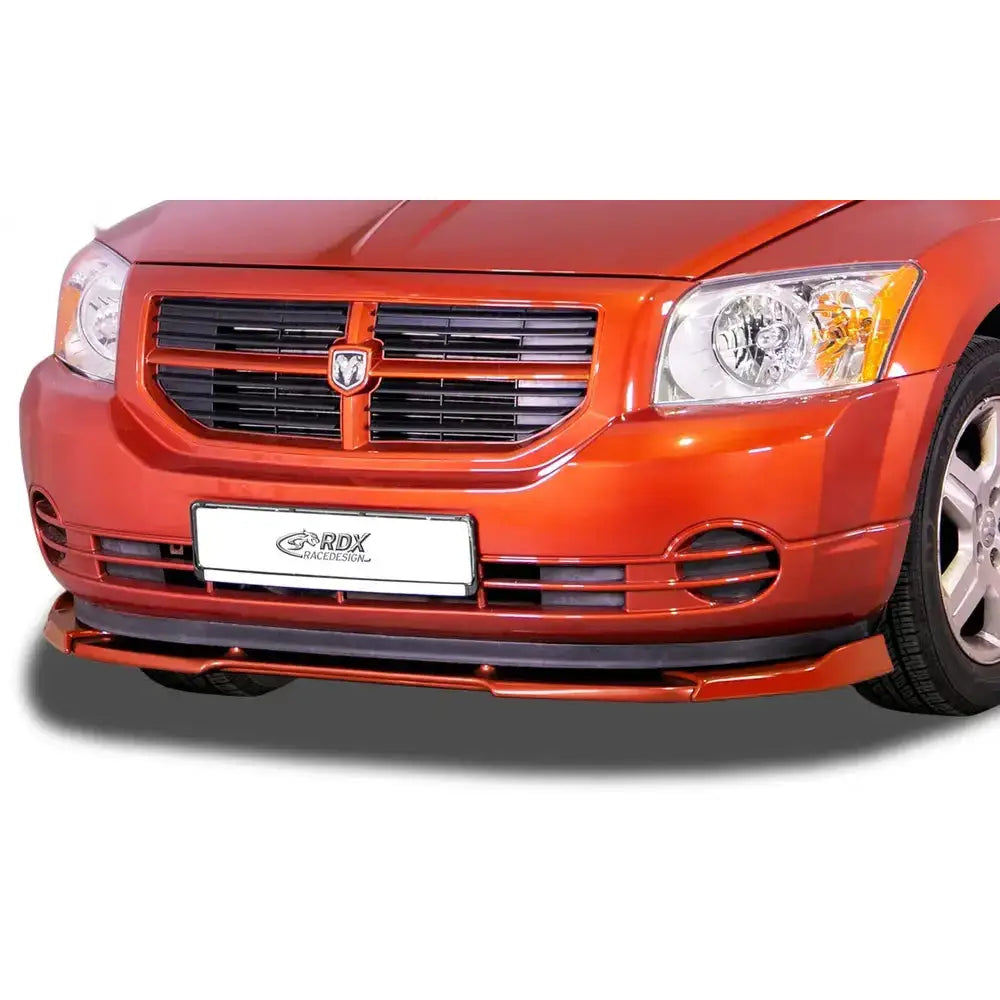 Frontspoiler Dodge Caliber 06-12 Vario X på oransje bil med svart grill og RDX-logo på nummerplaten.
