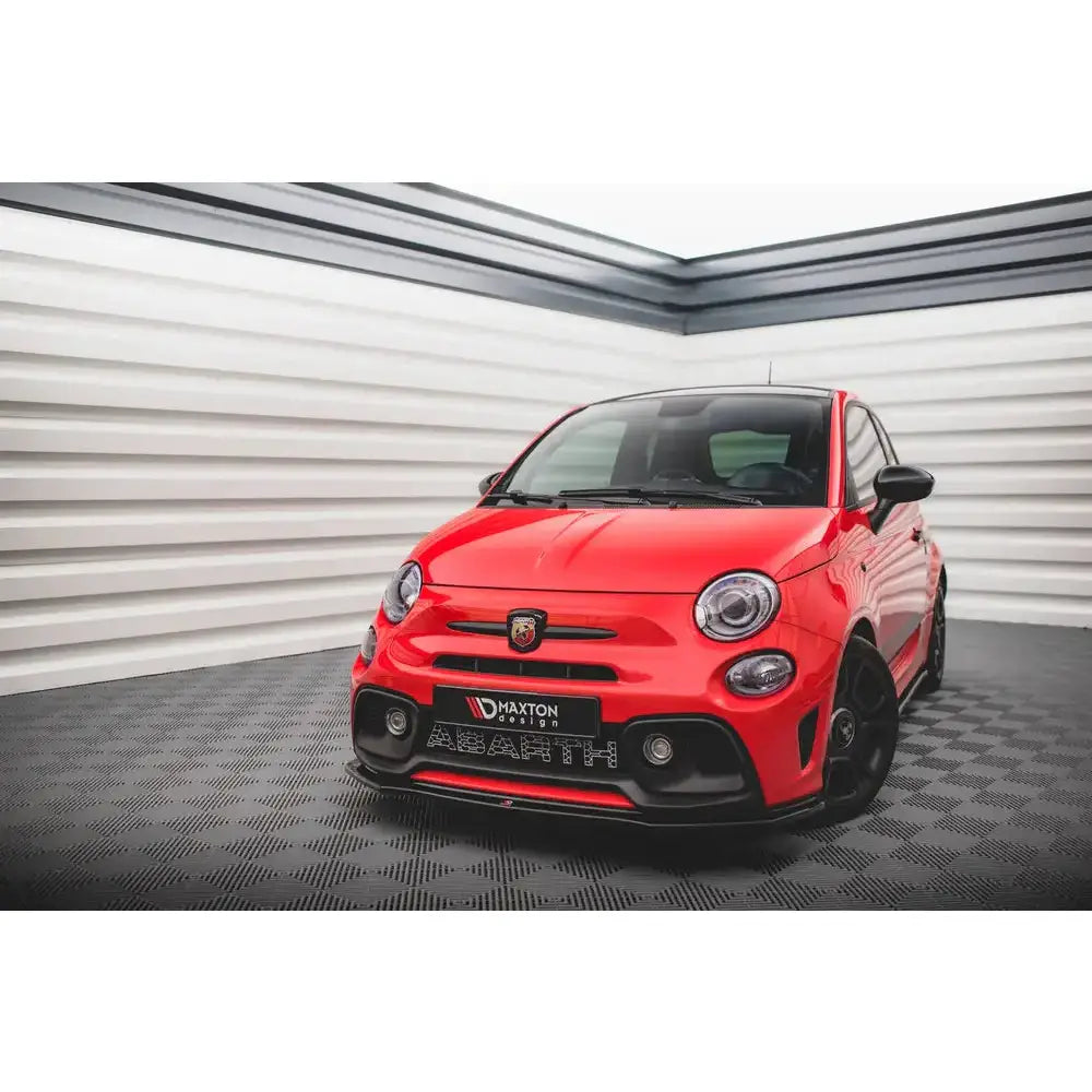 Frontleppe på rød Fiat 500 Abarth Mk1 Facelift med sorte detaljer, sett skrått forfra innendørs.