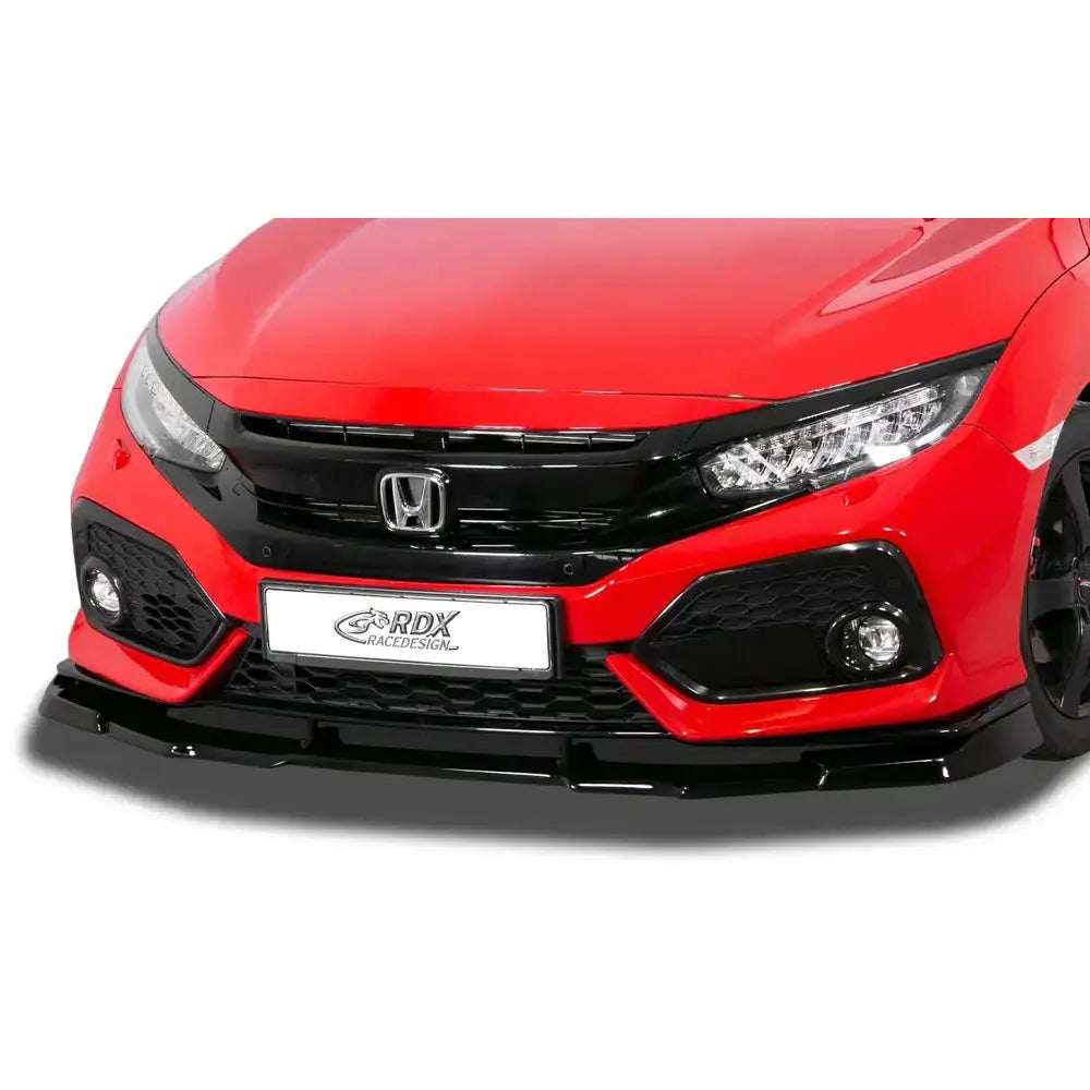 Frontspoiler på rød Honda Civic 17- sett forfra, viser svart spoiler, grill, lykter og tåkelys i detalj.