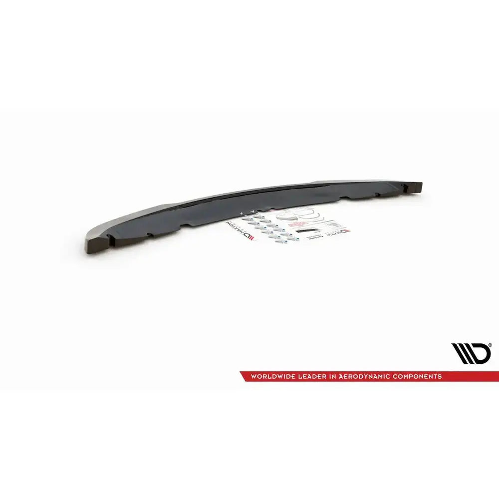 Frontspoiler Mini Cooper R50 i sort plast sett fra skrå vinkel med monteringsutstyr og instruksjoner.