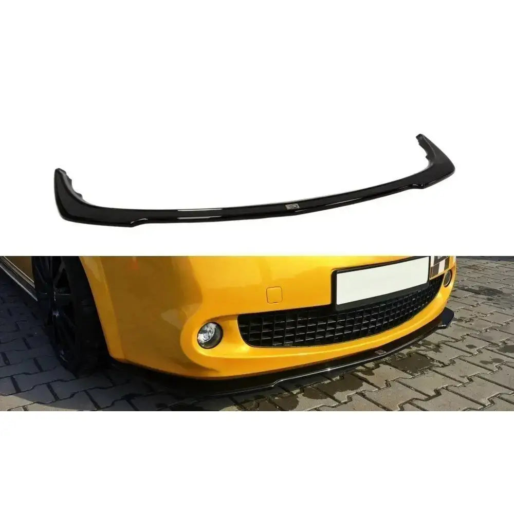 Frontspoiler til Renault Megane II Rs facelift i svart blank plast, vist montert på gul bilfront.
