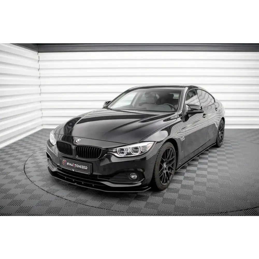 Frontleppe Street Pro BMW 4 Gran Coupe F36 på sort bil med svarte felger og LED-frontlykter, innendørs.