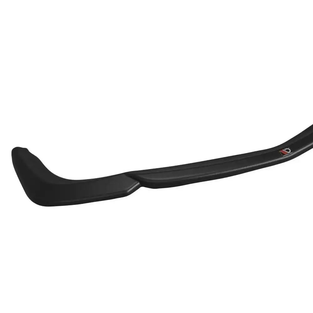 Frontspoiler Mercedes CLS C219 V.1 55AMG i sort plast, sidevisning med rød og sølv logo mot hvit bakgrunn.